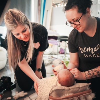 Lauren Shaw and Fru Jonas working together during a newborn feeding break