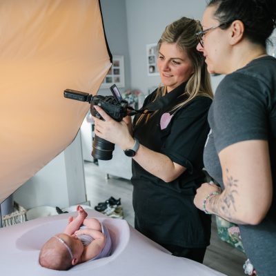 Lauren Shaw and Fru Jonas reviewing a shot during newborn photography training