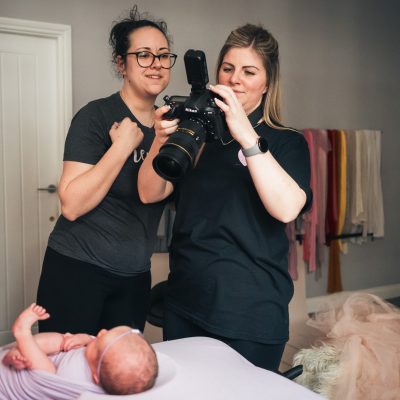 Lauren Shaw and Fru Jonas reviewing a shot during newborn photography training