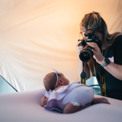 Lauren Shaw photographing a newborn baby during training session